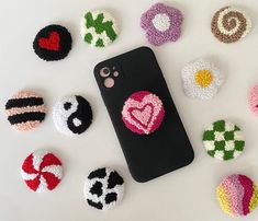 an iphone case with some crochet designs on it and several other cell phones