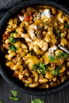 a bowl filled with macaroni and cheese on top of a table