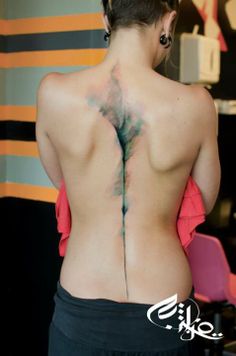 the back of a woman with tattoos on her body