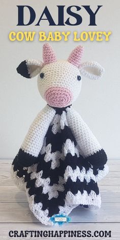 a crocheted cow is wearing a black and white dress with the words daisy on it