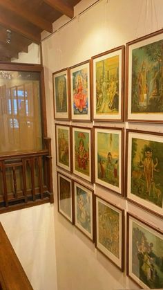 many paintings are hanging on the wall