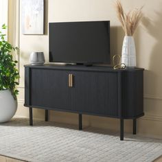 Embrace the sophisticated style and elevated functionality of our Tealla sideboard. Its linear profile and sleek rounded edges lend practical elegance and charm to any room. It features tambour doors on each side for added style and functionality. Each door slides horizontally to provide easy access to its spacious and roomy cabinets. The gold pulls of the cabinet create a warm contrast with the black finish of the storage unit. The two roomy cabinets open up to interior shelving to store anythi Credenza Entryway, Entrance And Living Room, Tambour Doors, Storage For Living Room, Console Cabinet, Storage Credenza, Entryway Console, Entertaining Essentials, Tv Stands And Entertainment Centers