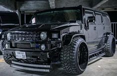 a black hummer is parked in a parking garage