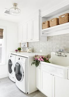 a washer and dryer in a white laundry room