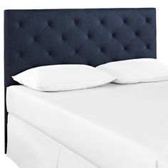 an upholstered headboard with white pillows on the top and bottom part of it