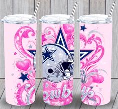 three personalized tumblers with football helmets and stars on them, all decorated in pink