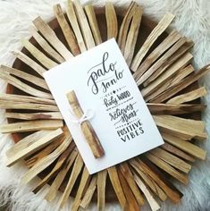 a piece of wood sitting on top of a white rug next to a pen and paper