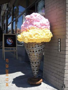 an ice cream cone with pink and yellow frosting