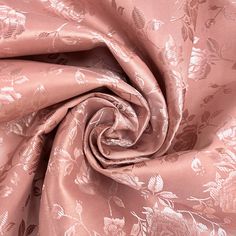 an image of a rose colored fabric with leaves on the back and side, as well as