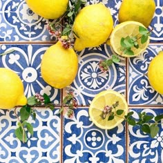 several lemons are arranged on a blue and white tile