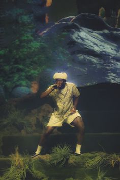 a man standing on top of a lush green field