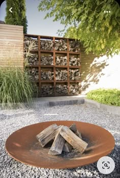 a fire pit in the middle of a gravel area