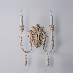 Available in an old white finish, this two-light metal wall sconce is eye-catching with its dramatic center column and twisted arms. The candlestick lamp features realistic wax drip detailing for a wonderful traditional touch. PRODUCT NOTES D 23cm x W 19cm x H 45cm / ∅ 9.1″ x W 7.5″ x H 17.7″. D 31cm x W 19cm x H 45cm / ∅ 12.2″ x W 7.5″ x H 17.7″. Old white. SKU: RDW-172518 MATERIALS Iron body. E14 socket. (Not included bulbs) SPEC SHEET Wall Lamps Living Room, Candlestick Lamps, Wall Sconces Bedroom, Sconces Bedroom, Iron Body, Lamps Ceiling, Lamps Living Room, Light Table, Light Accessories