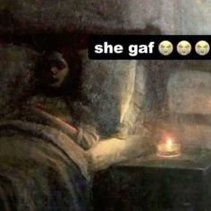 a painting with the words she gaf on it in front of a lit candle