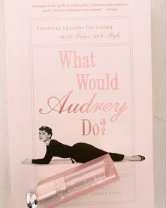 an advertisement for the perfume brand, what would audrey do? with a woman laying on her stomach