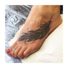 a woman's foot with a feather tattoo on it