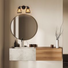 a bathroom with a sink, mirror and two lights on the wall next to it