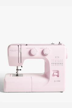 a pink sewing machine sitting on top of a white table