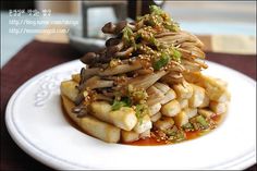 a white plate topped with food on top of a wooden table