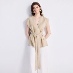 Our Power Moves Top is a wardrobe must-have, your ultimate summer staple! This beautiful wrap top in neutral beige works as well for the office as it does for a dinner with friends. Pair it with sleek trousers or a pair of jeans and see where your day takes you. Versatile Beige V-neck Blouse, Beige V-neck Blouse For Office, V-neck Wrap Top With Tie Waist For Work, Chic Taupe V-neck Top, Elegant Beige Linen Top, Summer Khaki V-neck Blouse, Beige V-neck Top For Office, Beige V-neck Top For Work, Feminine Beige Linen Blouse