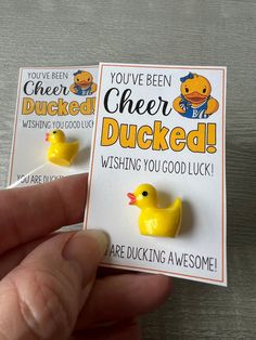 two yellow rubber ducks sitting on top of a white card with the words you've been ducked