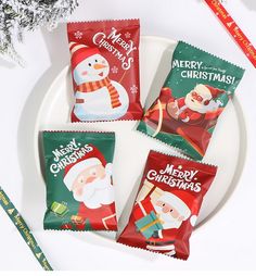 three christmas candy bars sitting on top of a white plate