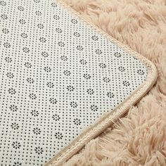 a close up view of a mattress on a fluffy rug with holes in the middle