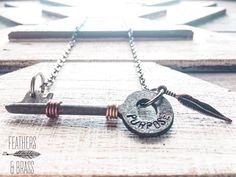 a bottle opener with a key attached to it sitting on top of a wooden table