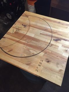 a wooden table with writing on it in a room filled with other items and tools