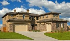 a large house with two garages on the front