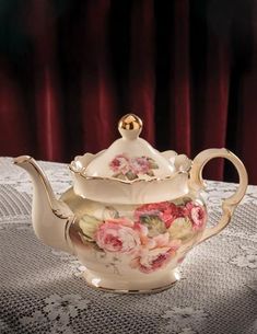 a tea set with pink flowers on it