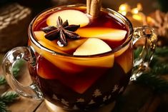 an apple cider with cinnamon and star anise on the top in a glass mug