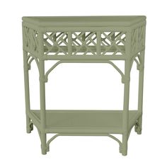 the side table is painted green and has an intricate design on it's sides