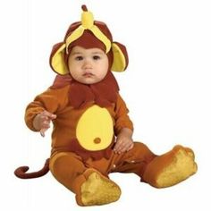 a baby in a monkey costume sitting on the floor