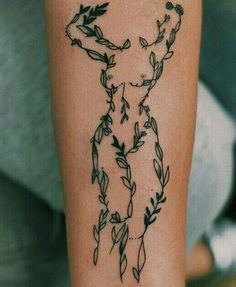 a tattoo on the leg of a woman with flowers and leaves around her body,