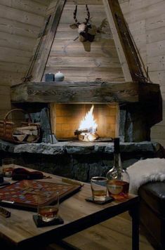 a living room filled with furniture and a fire place in the middle of it's fireplace