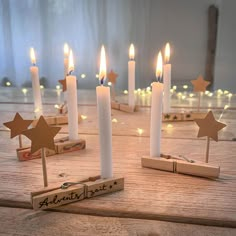 several candles with wooden stars on them