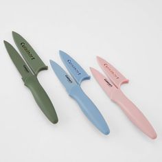 three different colored knives sitting next to each other