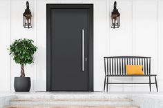 a black front door on a white house with a bench and potted plant next to it