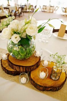 the centerpieces are made out of wood slices and have white flowers in them