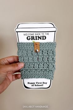 someone is holding up a crocheted coffee cup cozy that says, welcome back to the grind