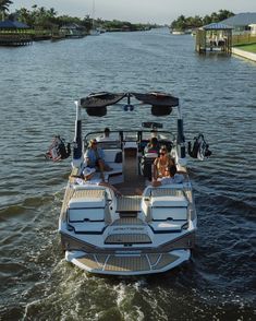 people are riding on the back of a boat