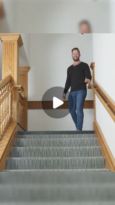 a man is walking down the stairs with his hands in his pockets