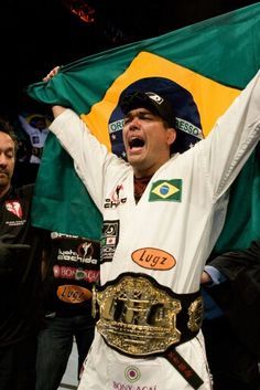 a man holding up a flag and wearing a belt