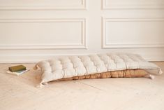 a white couch sitting on top of a hard wood floor