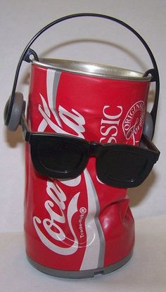 a can with sunglasses and headphones attached to it