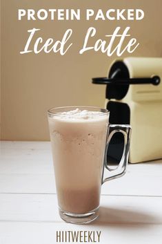 a glass filled with ice cream next to a blender