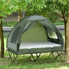 a tent set up next to some trees