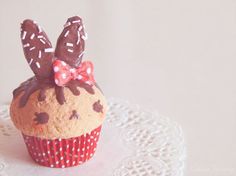 a cupcake with chocolate frosting and bunny ears on top