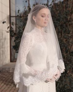 a woman wearing a wedding dress and veil